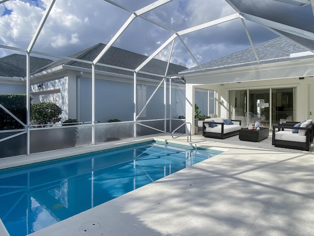 view of swimming pool with outdoor lounge area, glass enclosure, ceiling fan, and a patio