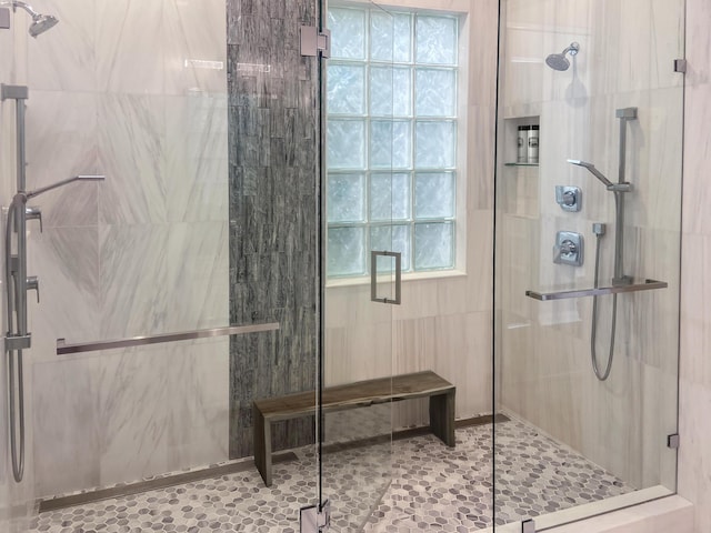 bathroom featuring a shower with door