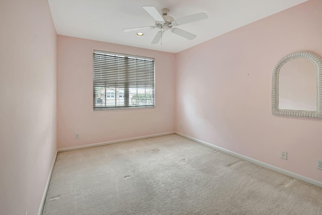 unfurnished room featuring ceiling fan and light carpet