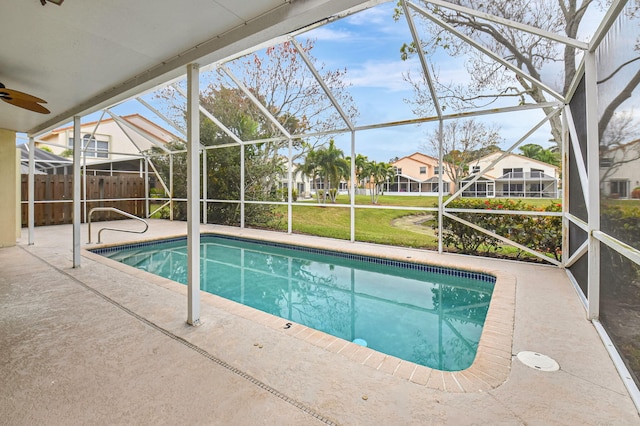 view of pool with a lanai, a lawn, and a patio area