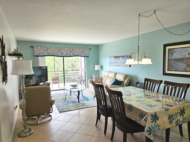 dining area featuring an inviting chandelier and light tile patterned floors