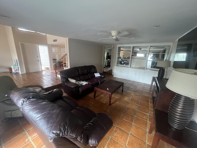 living room featuring ceiling fan, tile patterned floors, built in features, and plenty of natural light