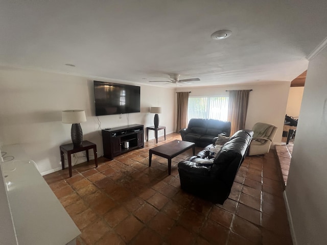 living room with ceiling fan and ornamental molding