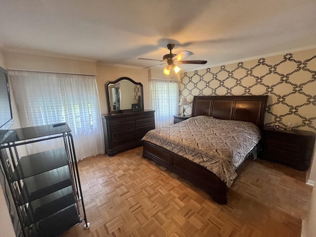 bedroom with ceiling fan, ornamental molding, and light parquet floors