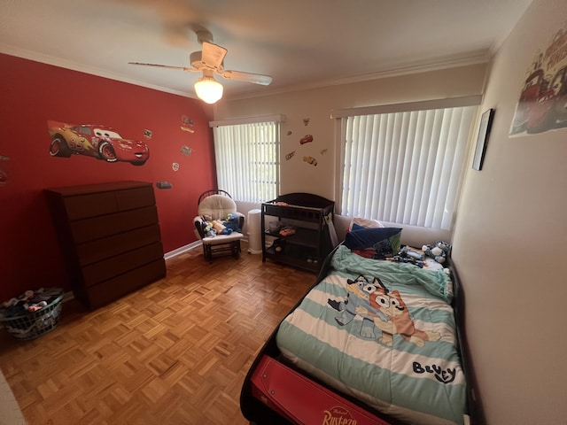 bedroom featuring ceiling fan, crown molding, and light parquet flooring