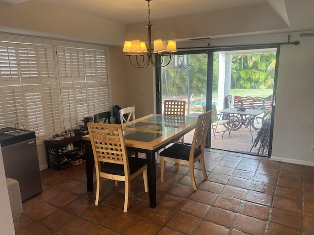 dining area featuring an inviting chandelier