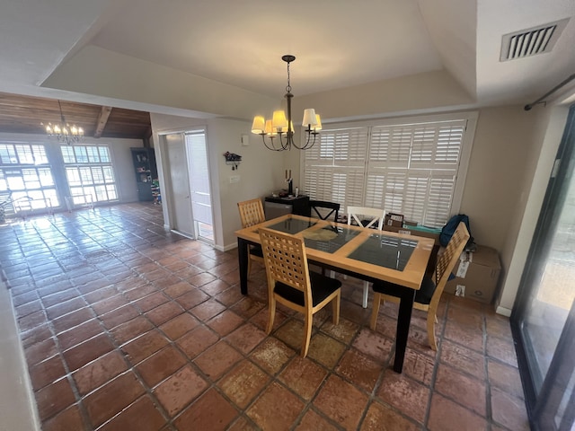 tiled dining space with a chandelier and beam ceiling