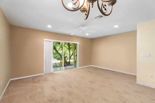 unfurnished room with carpet floors and ceiling fan with notable chandelier