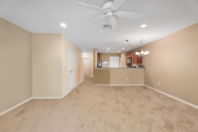 interior space featuring light carpet and ceiling fan with notable chandelier