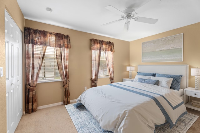 bedroom with ceiling fan, a closet, and light carpet