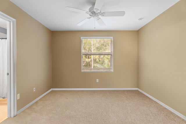 empty room featuring light carpet and ceiling fan