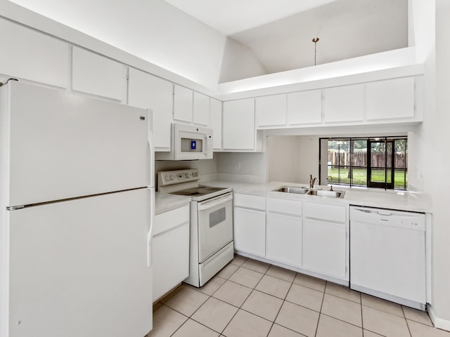 kitchen with white appliances, white cabinets, light tile patterned floors, and sink