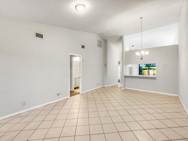 unfurnished living room with vaulted ceiling, a textured ceiling, light tile patterned flooring, and a notable chandelier