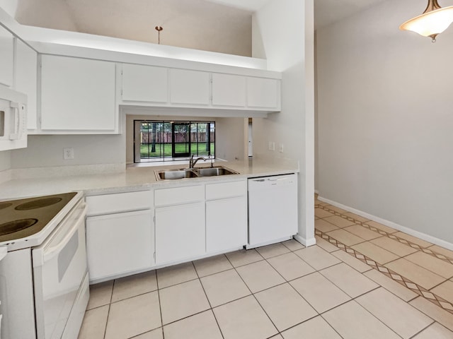 kitchen with sink, white appliances, light tile patterned floors, and white cabinets