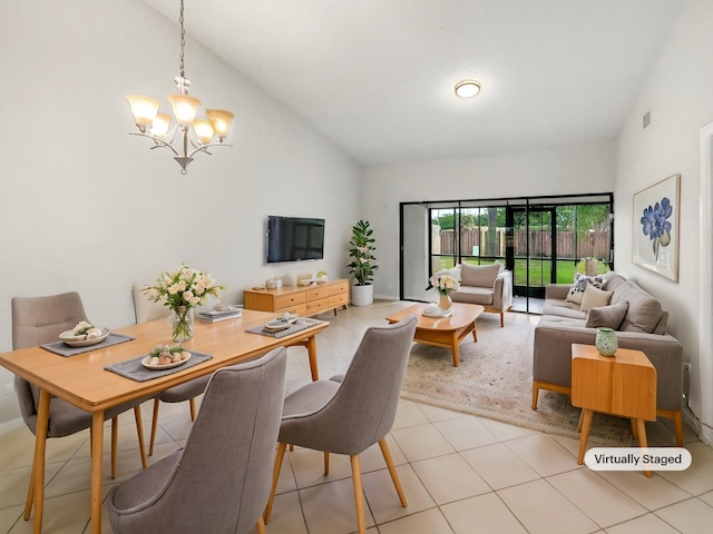 tiled dining space with high vaulted ceiling and a chandelier