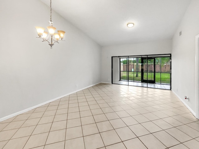 tiled empty room with a chandelier