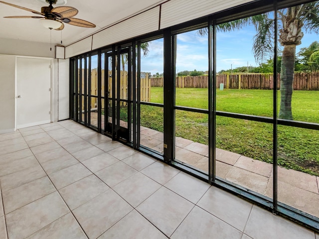 unfurnished sunroom with ceiling fan and a wealth of natural light