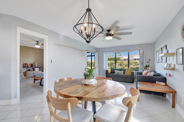 dining space with ceiling fan with notable chandelier and light tile patterned floors