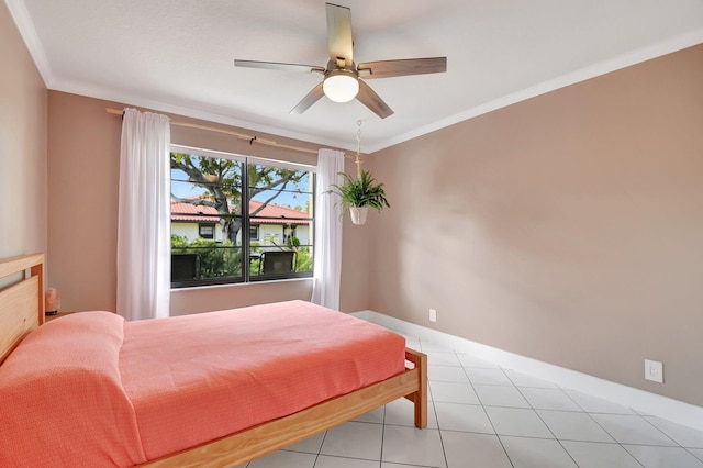 tiled bedroom with ornamental molding and ceiling fan