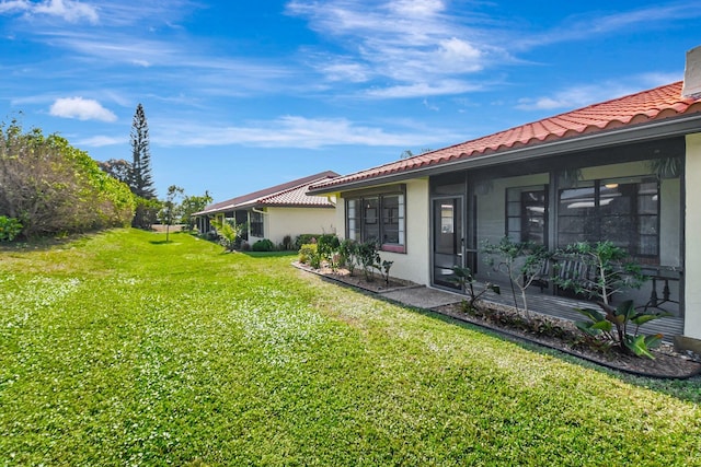 view of yard with a sunroom