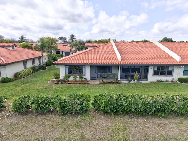 rear view of property with a lawn