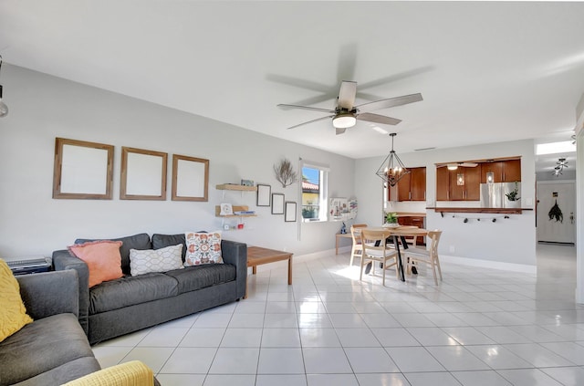 living room with ceiling fan with notable chandelier and light tile patterned flooring