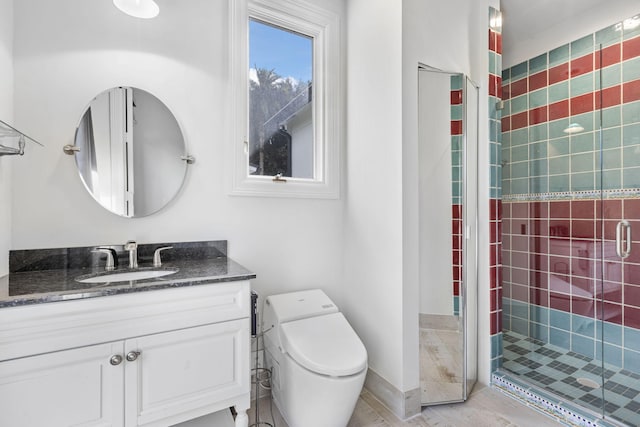 bathroom with toilet, a shower with shower door, and vanity