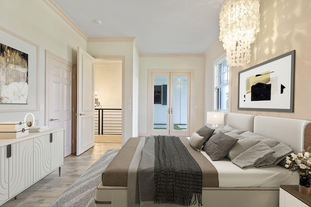 bedroom with ornamental molding, a chandelier, and light hardwood / wood-style flooring