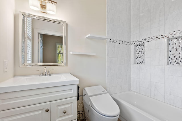 full bathroom with toilet, vanity, and tiled shower / bath