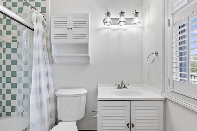 bathroom featuring toilet and vanity