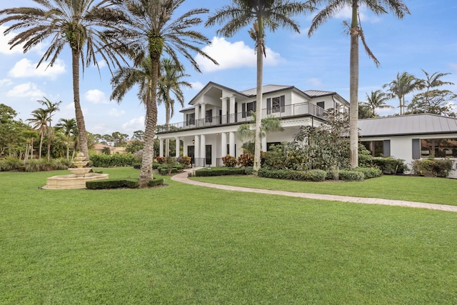 view of front of property with a front lawn and a balcony