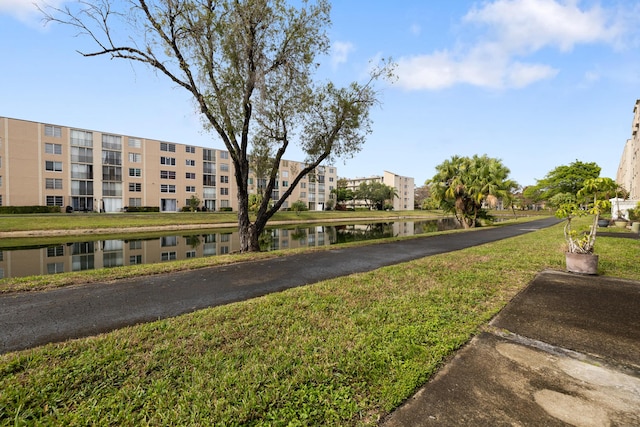 view of property's community featuring a water view and a yard