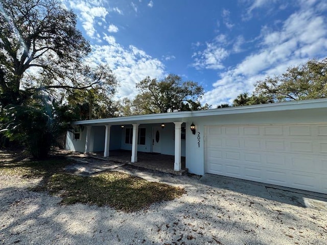 view of front of house featuring a porch and a garage