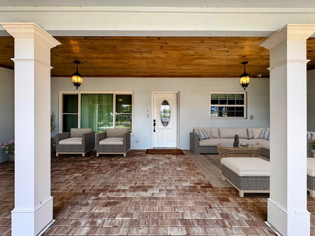 doorway to property featuring stucco siding and an outdoor hangout area