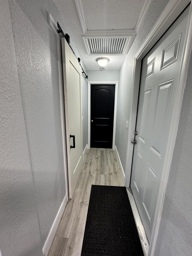 laundry area with light wood-type flooring, stacked washer and clothes dryer, and electric water heater