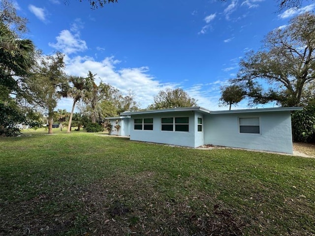 rear view of house with a yard