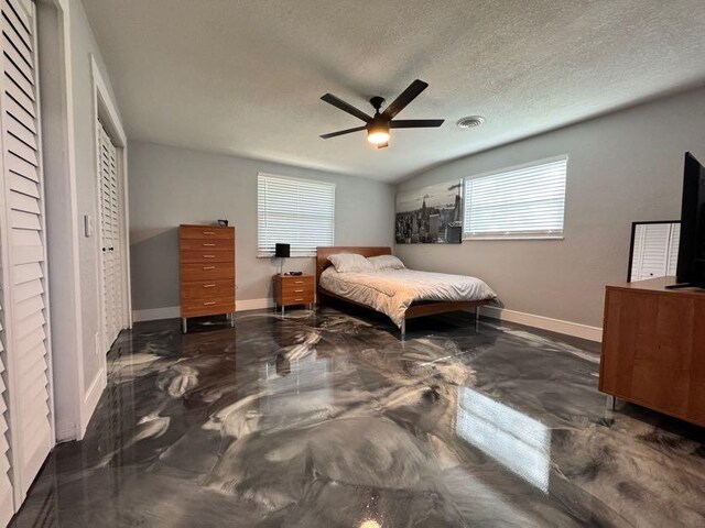 bedroom with a closet, ceiling fan, vaulted ceiling, and a textured ceiling