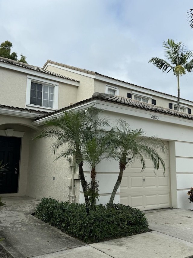 view of side of home featuring a garage