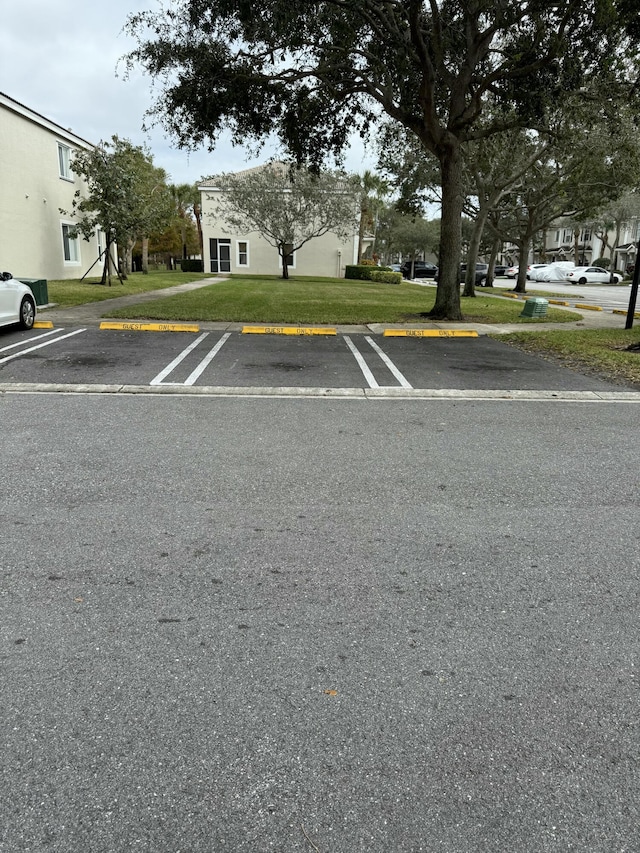 view of parking featuring a lawn