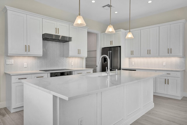 kitchen with pendant lighting, white cabinets, and high end fridge