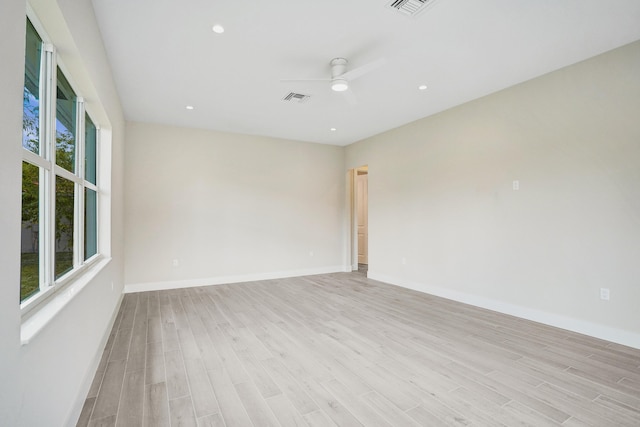 spare room with light hardwood / wood-style floors and ceiling fan