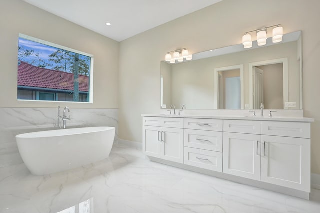 bathroom with vanity, tile walls, and a tub