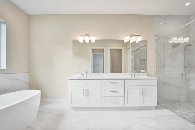 bathroom with vanity and shower with separate bathtub