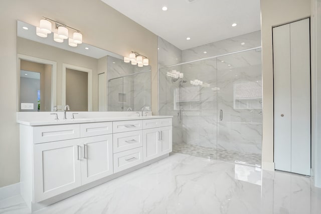 bathroom featuring a shower with shower door and vanity