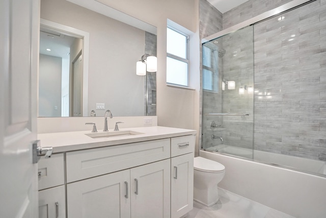 full bathroom featuring bath / shower combo with glass door, toilet, and vanity