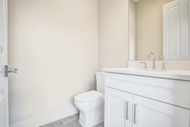 bathroom with toilet and vanity