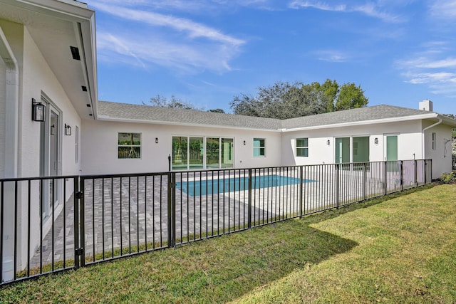 view of swimming pool with a patio area and a yard