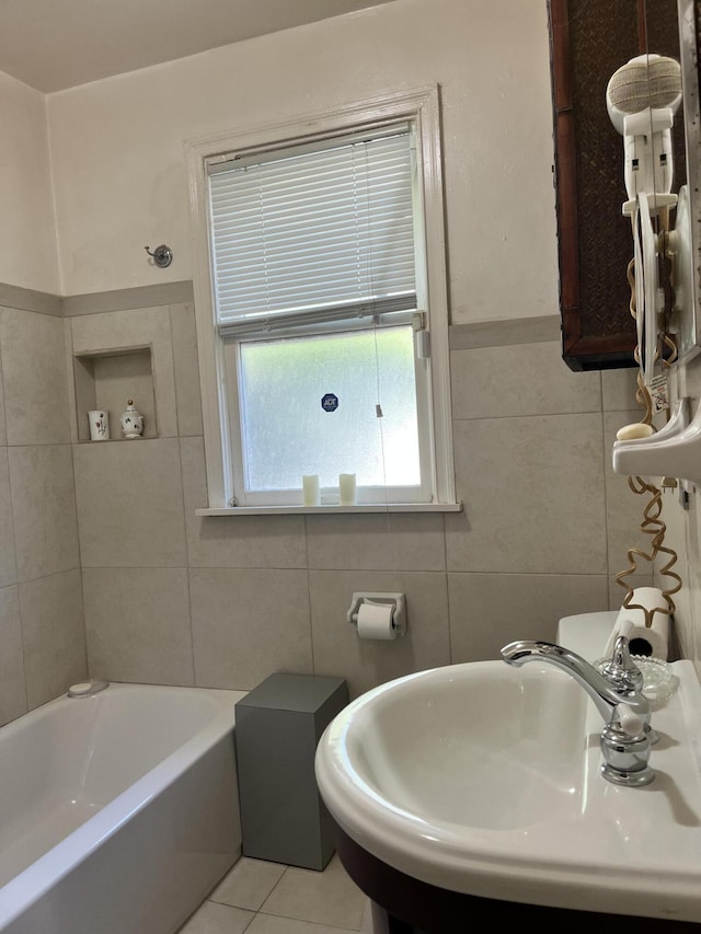 bathroom with sink, tile walls, and tile patterned flooring