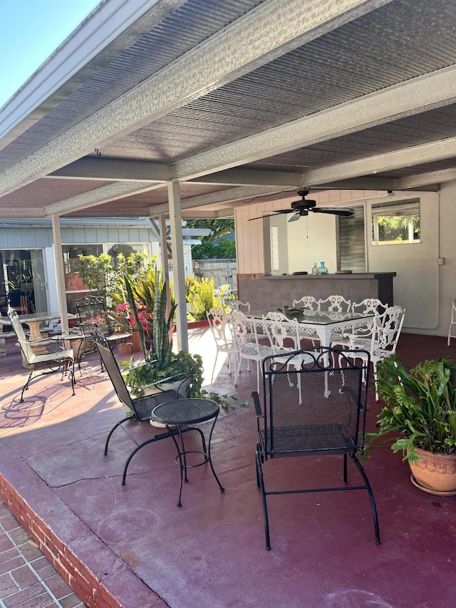 view of patio featuring ceiling fan and an outdoor bar