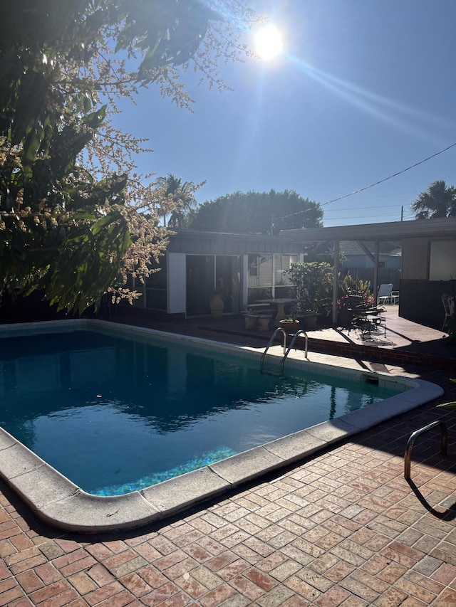 view of swimming pool featuring a patio area